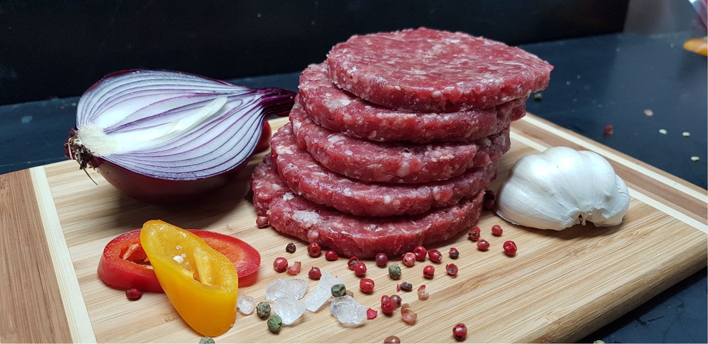 Beef burgers on a board